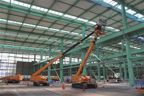 Booms at work in a typical steel construction application. 